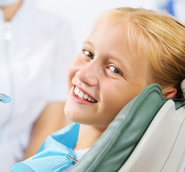 Smiling young girl in dental chair