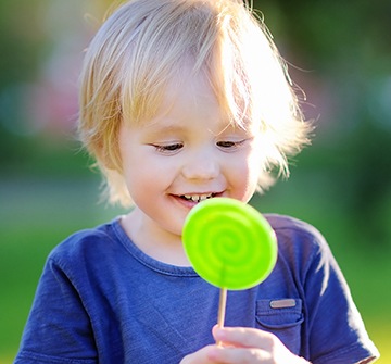 Little boy with a green sucker