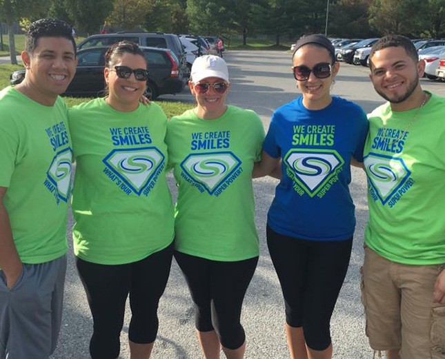 Five team members in matching shirts