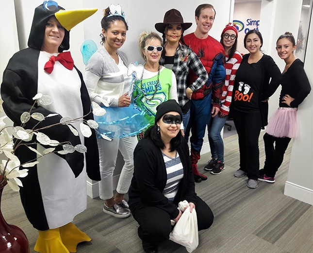 Team members in Halloween costumes