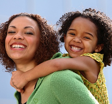 mother and daughter hugging smiling