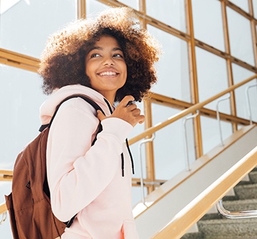 Teen girl smiling while walking up stairs