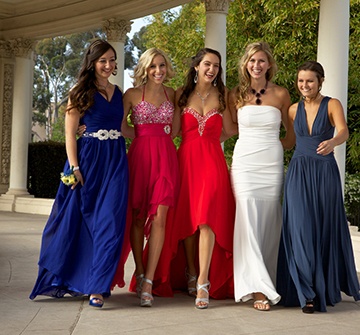 Group of teen girls smiling in prom dresses