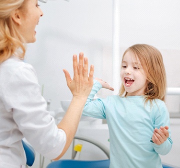 Child giving a dentist a high-five