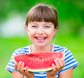 girl braces watermelon