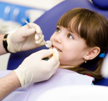 Girl receiving dental sealant treatment