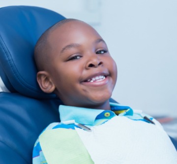 Smiling little boy in dental chair