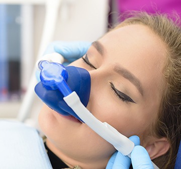 Young woman with nitrous oxide nose mask
