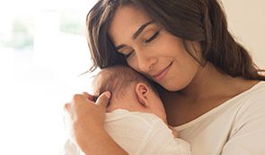 Mother holding sleeping baby