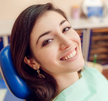 Smiling young woman in dental chair