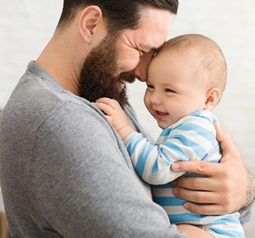 Father smiling while holding son