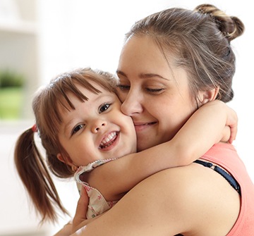 Mother hugging toddler