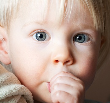 Young child sucking his thumb