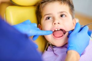 A little boy having his teeth examined