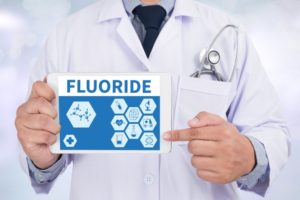 doctor pointing to fluoride on tablet