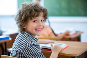 Little boy smiling in classroom