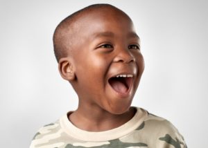 little boy smiles after visiting Fitchburg dentist for kids