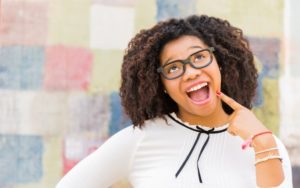 Teenager smiles at their dentist for teens in Fitchburg 