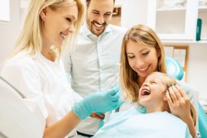 Family smiling during baby's first dental visit