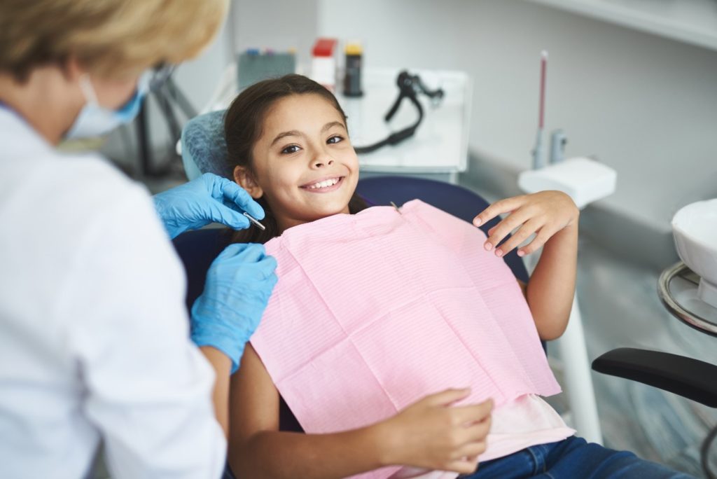 Closeup of child smiling in dentist's chair
