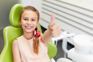 a child smiling during a dental appointment