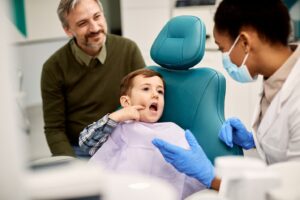 a child and his parent during a dental checkup and cleaning