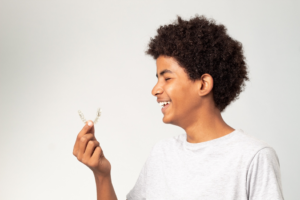 a teen with Invisalign smiling
