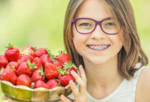 a child with braces smiling